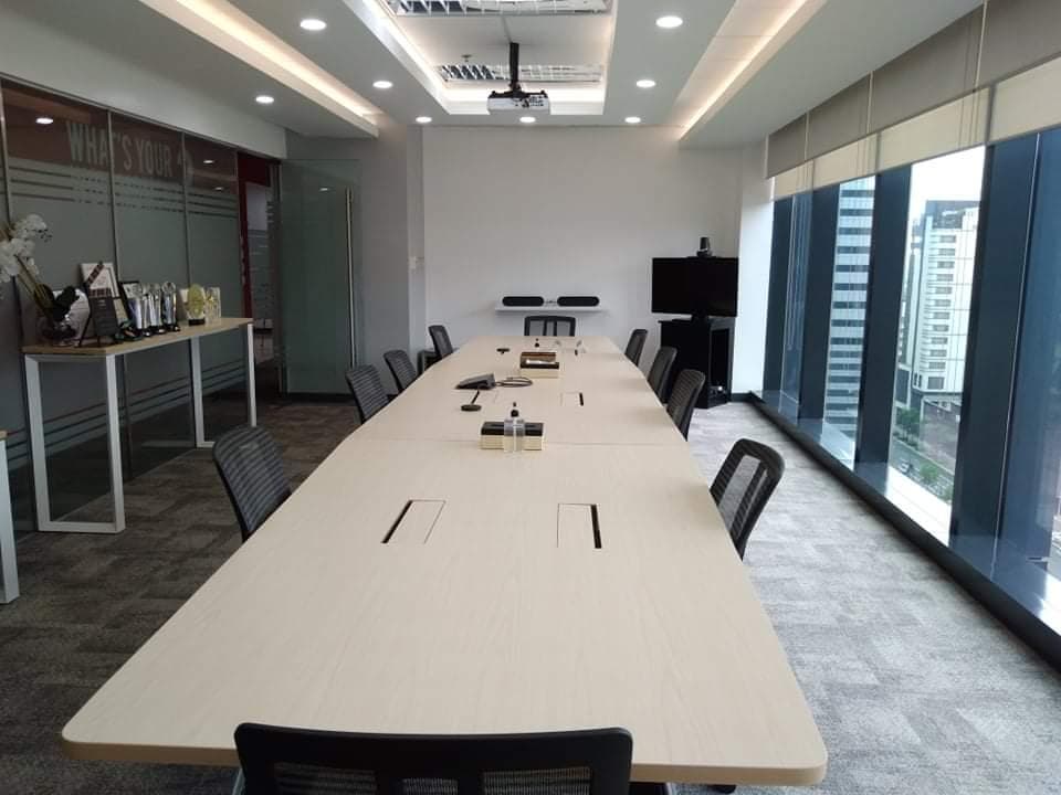 Conference room with a long table and floor-to-ceiling city views