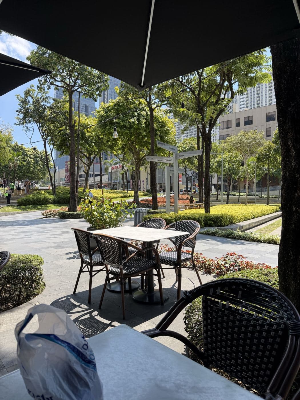 A café table on a shaded terrace in a BGC garden
